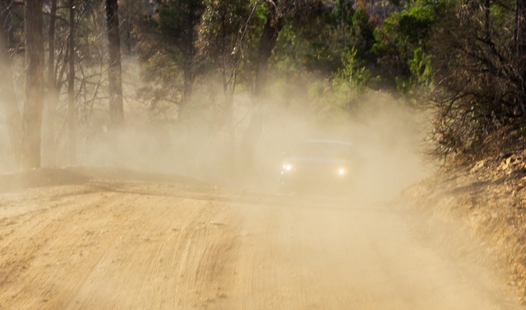 Dust suppression treatment being applied to a dry gravel access road