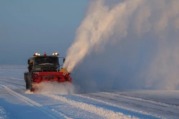 Snow removal and salting on a rural property access road in winter